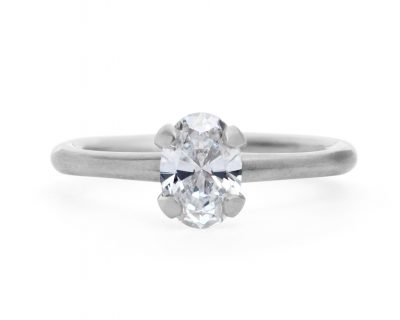 Oval white diamond and platinum sculpted four claw solitaire engagement ring
