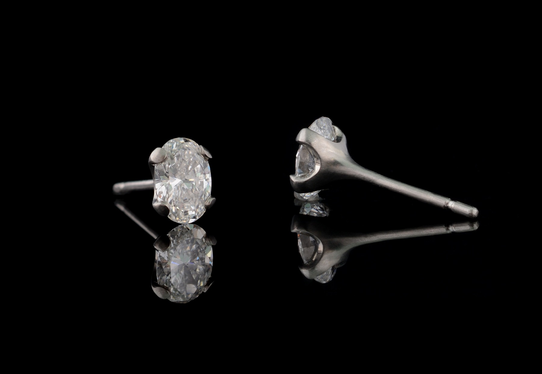 Platinum 4-claw stud earrings with oval white diamonds