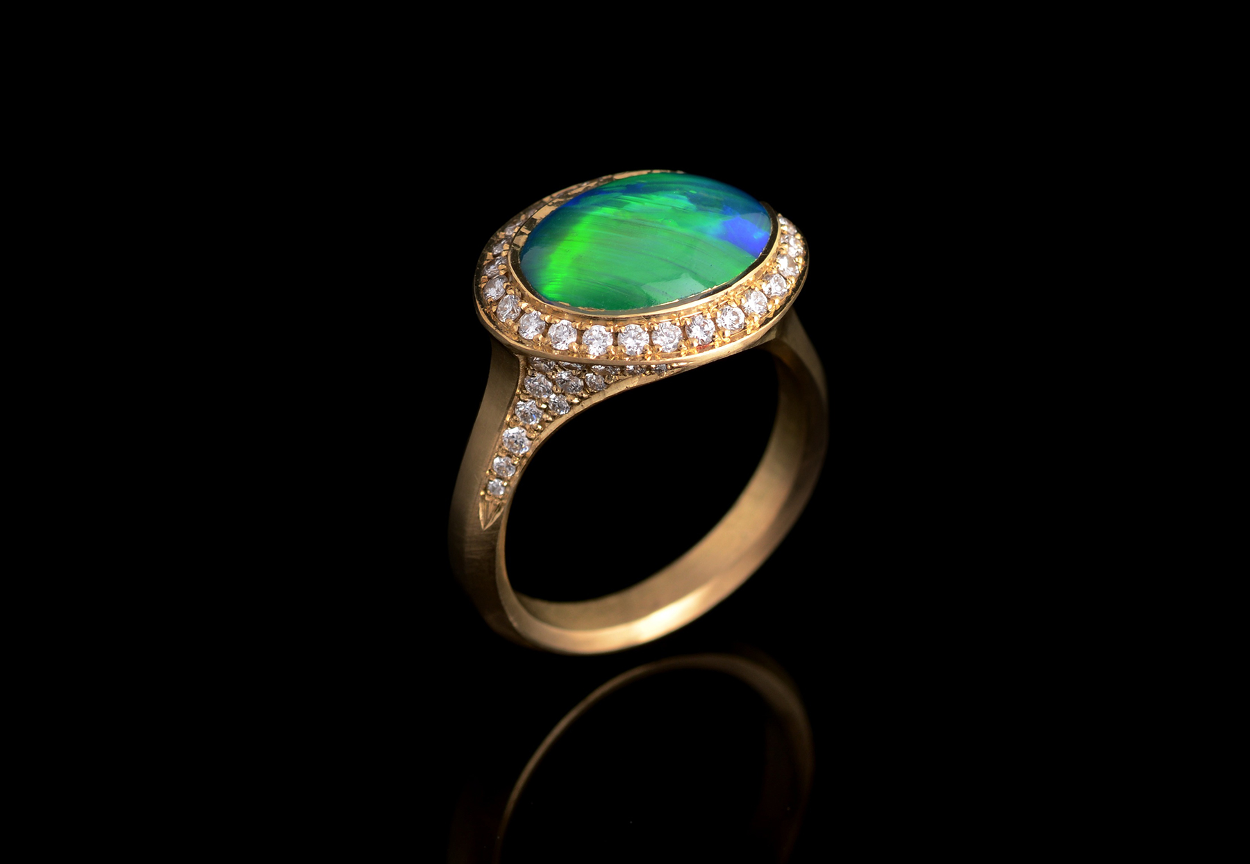 Bespoke yellow gold and opal ring with white diamond halo