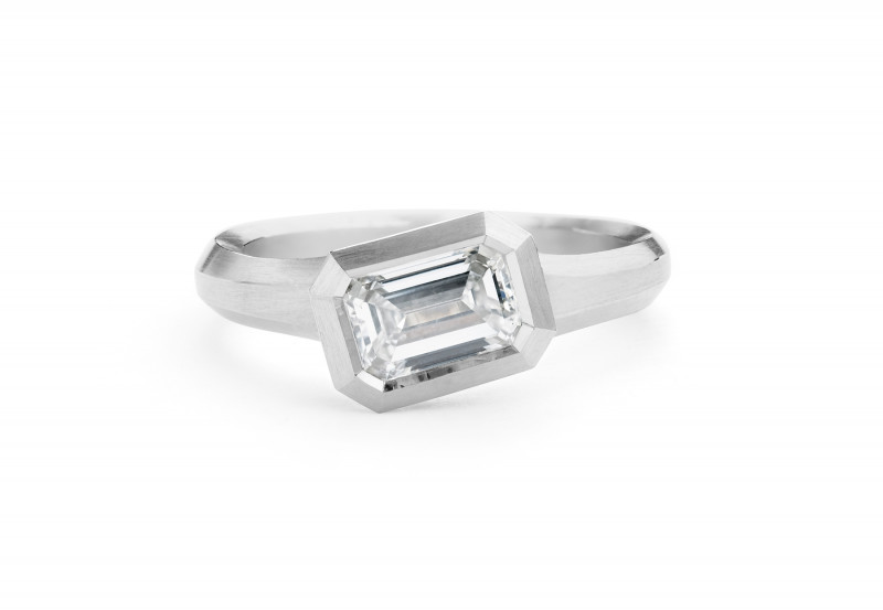 Arris carved platinum engagement ring with emerald-cut white diamond