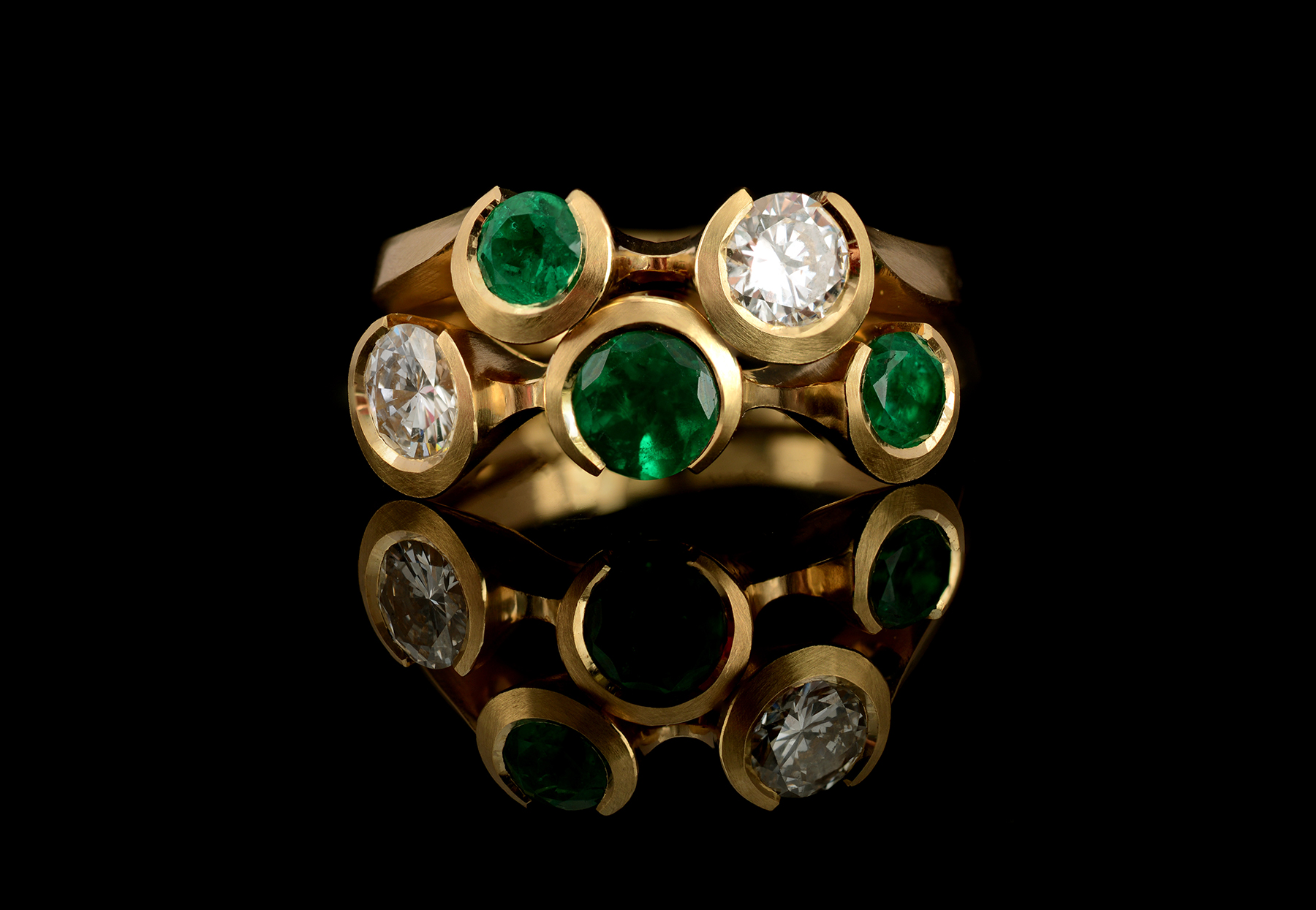 Bespoke Arris carved yellow gold rings set with emeralds and diamonds