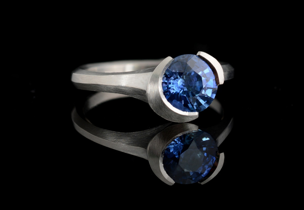 Arris carved platinum ring with round blue sapphire