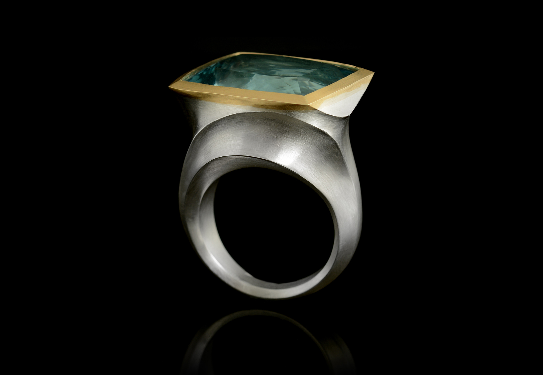 Arris silver and gold cocktail ring with blue gemstone