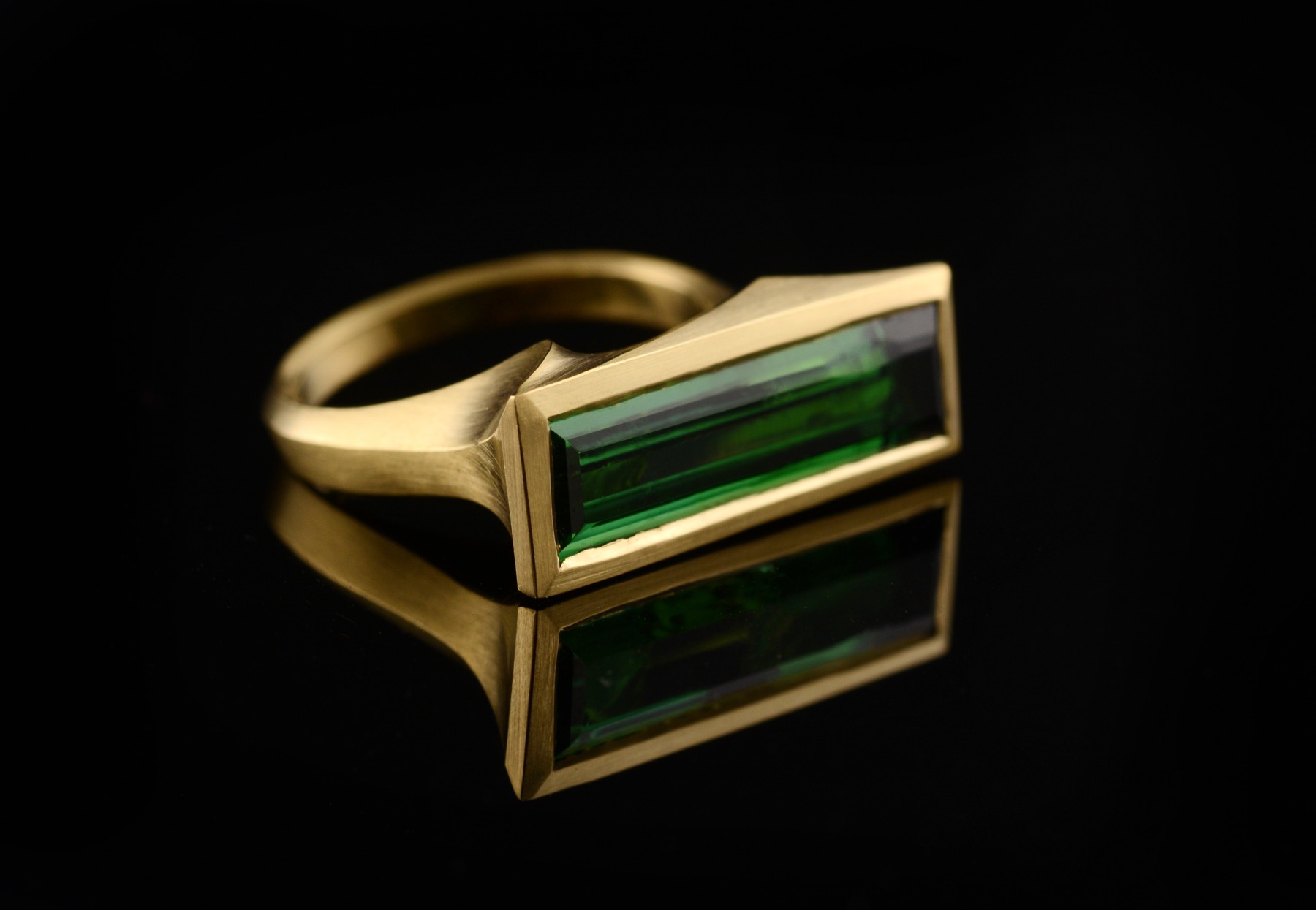 Arris carved gold cocktail ring with baguette green tourmaline