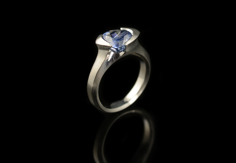 Carved platinum cocktail ring with trillion sapphire