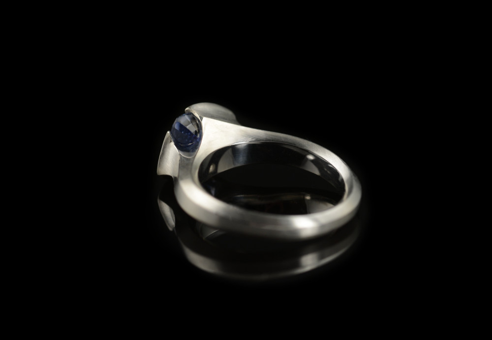 Hand carved platinum cocktail ring with blue trillion sapphire