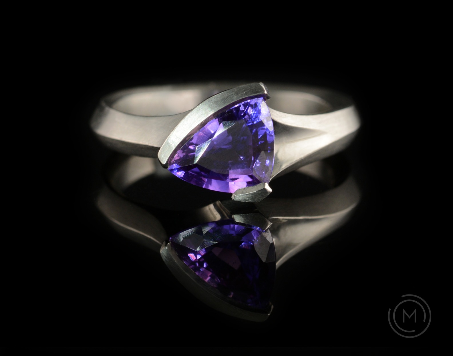 Carved platinum engagement ring with purple trillion sapphire
