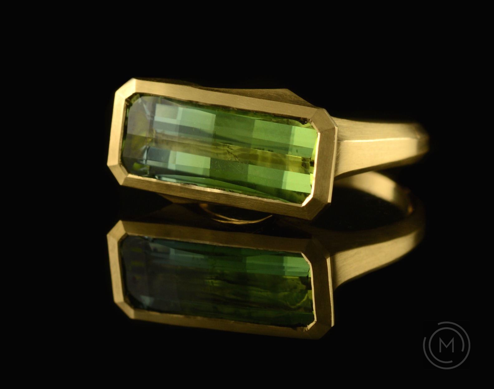 Arris carved yellow gold cocktail ring with fancy cut green tourmaline