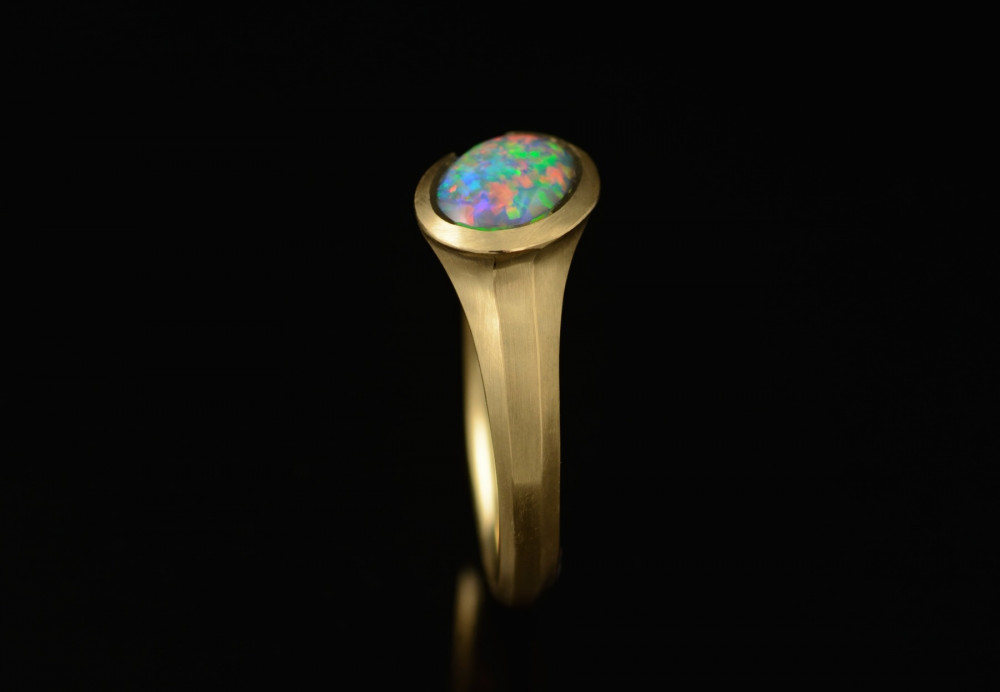 Carved yellow gold and Lightning Ridge black opal ring