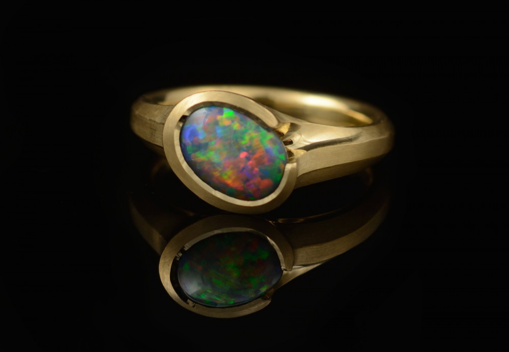 Carved yellow gold and Lightning Ridge black opal ring