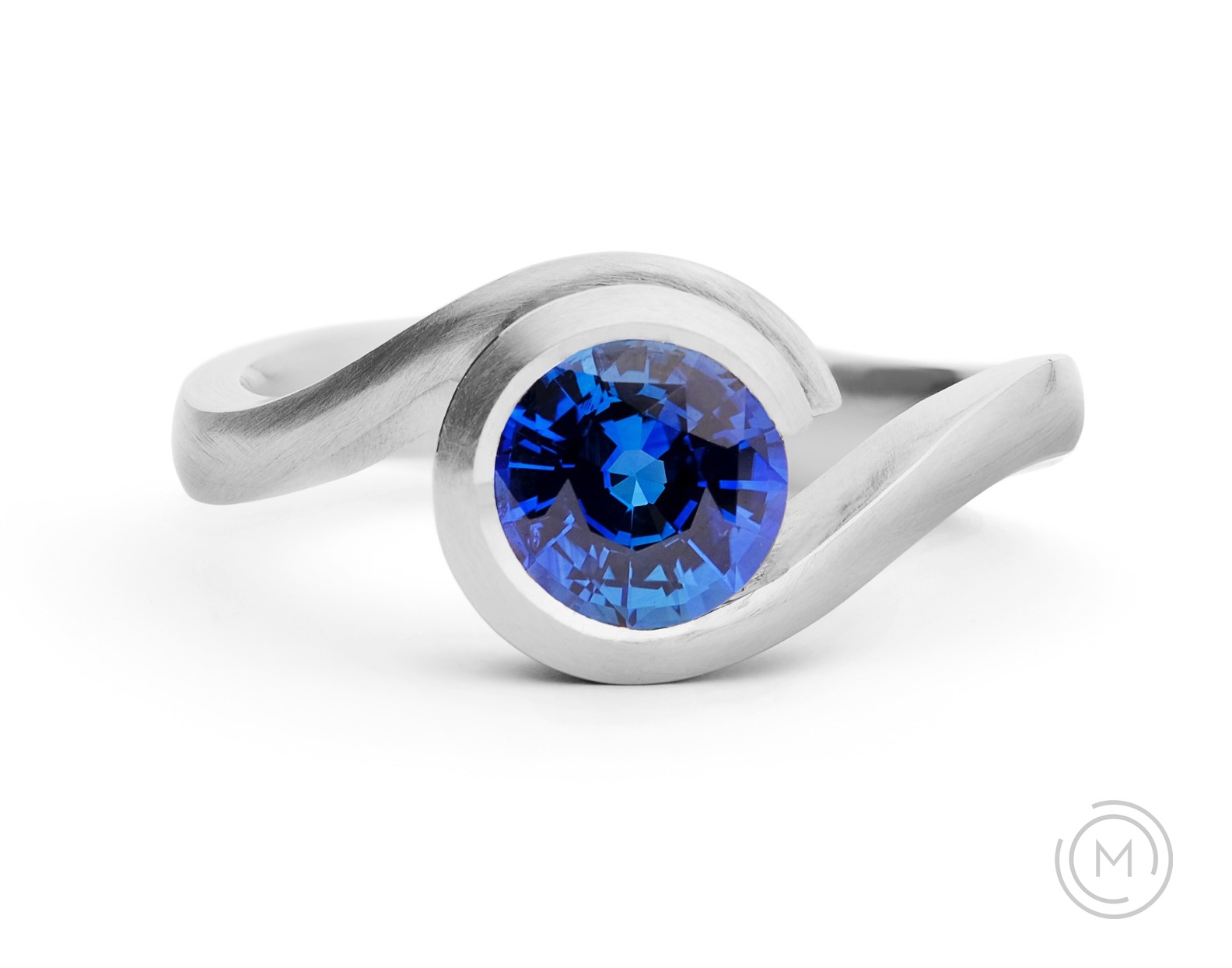 Contemporary blue sapphire and platinum engagement ring