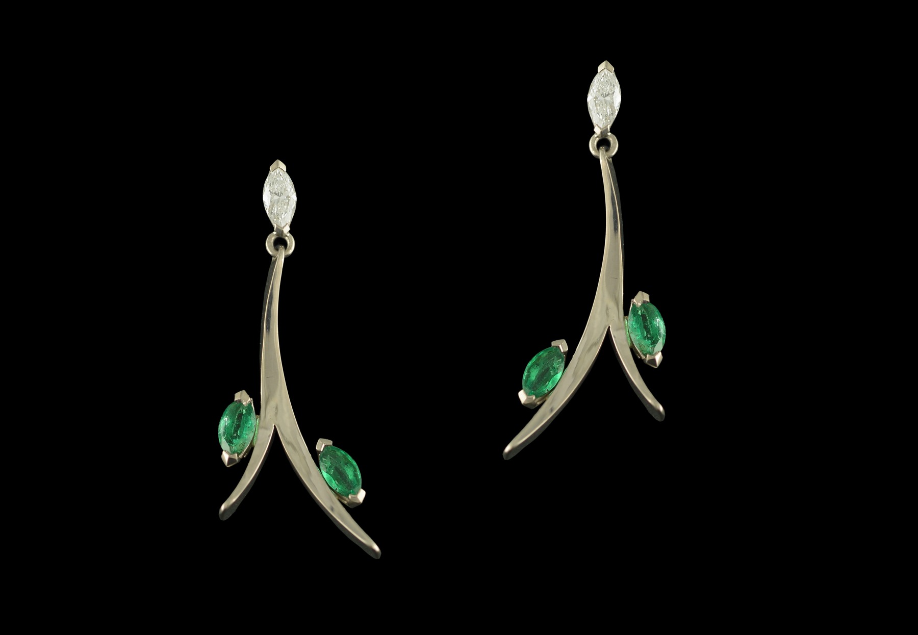 Forged white gold earrings set with marquise cut emeralds and diamonds