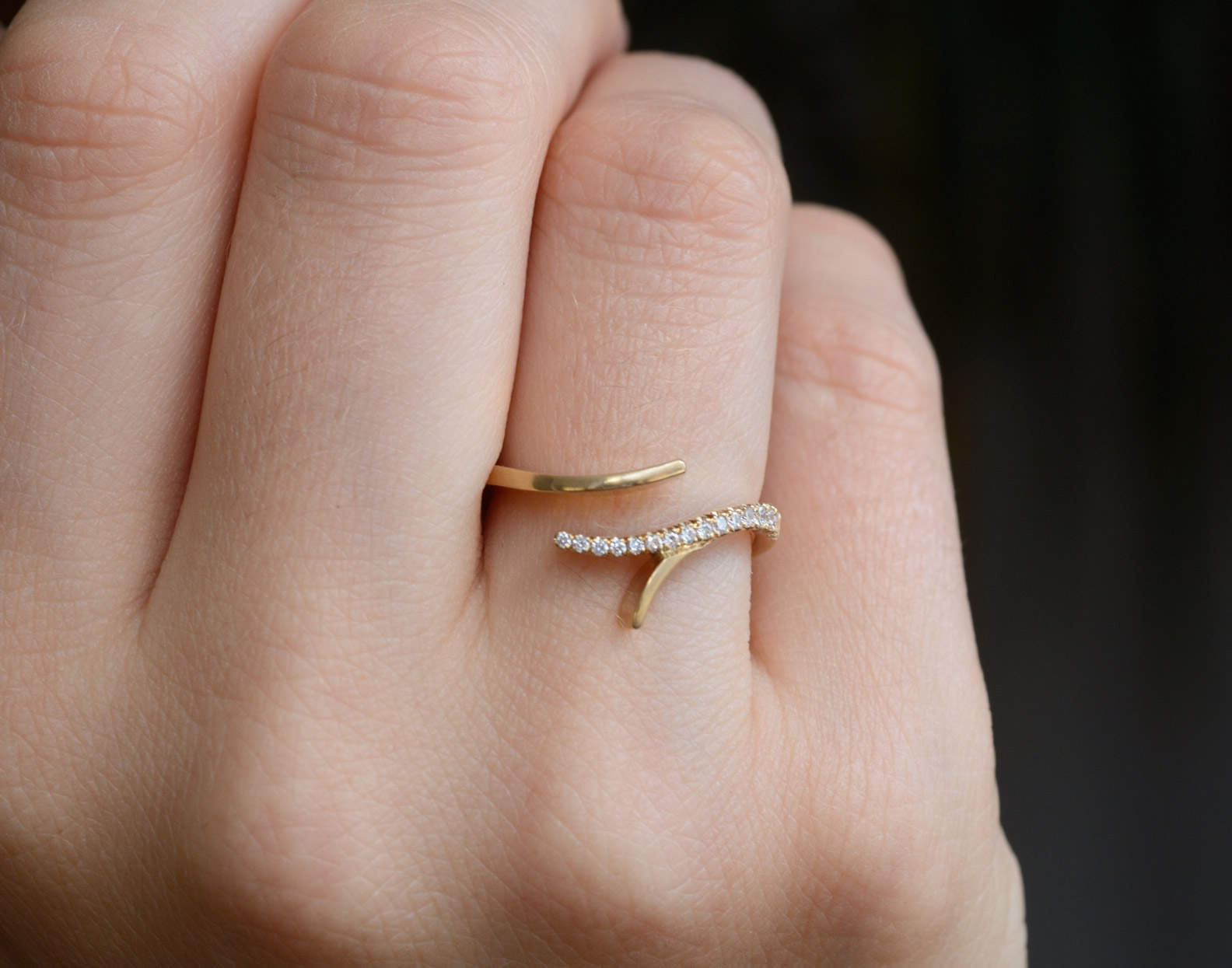 Forked yellow gold and diamond ring on hand