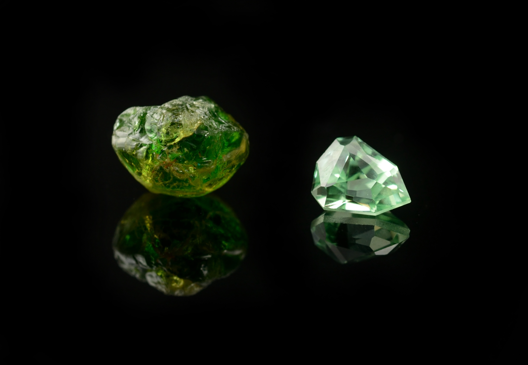 Rough and cut green garnet gemstones
