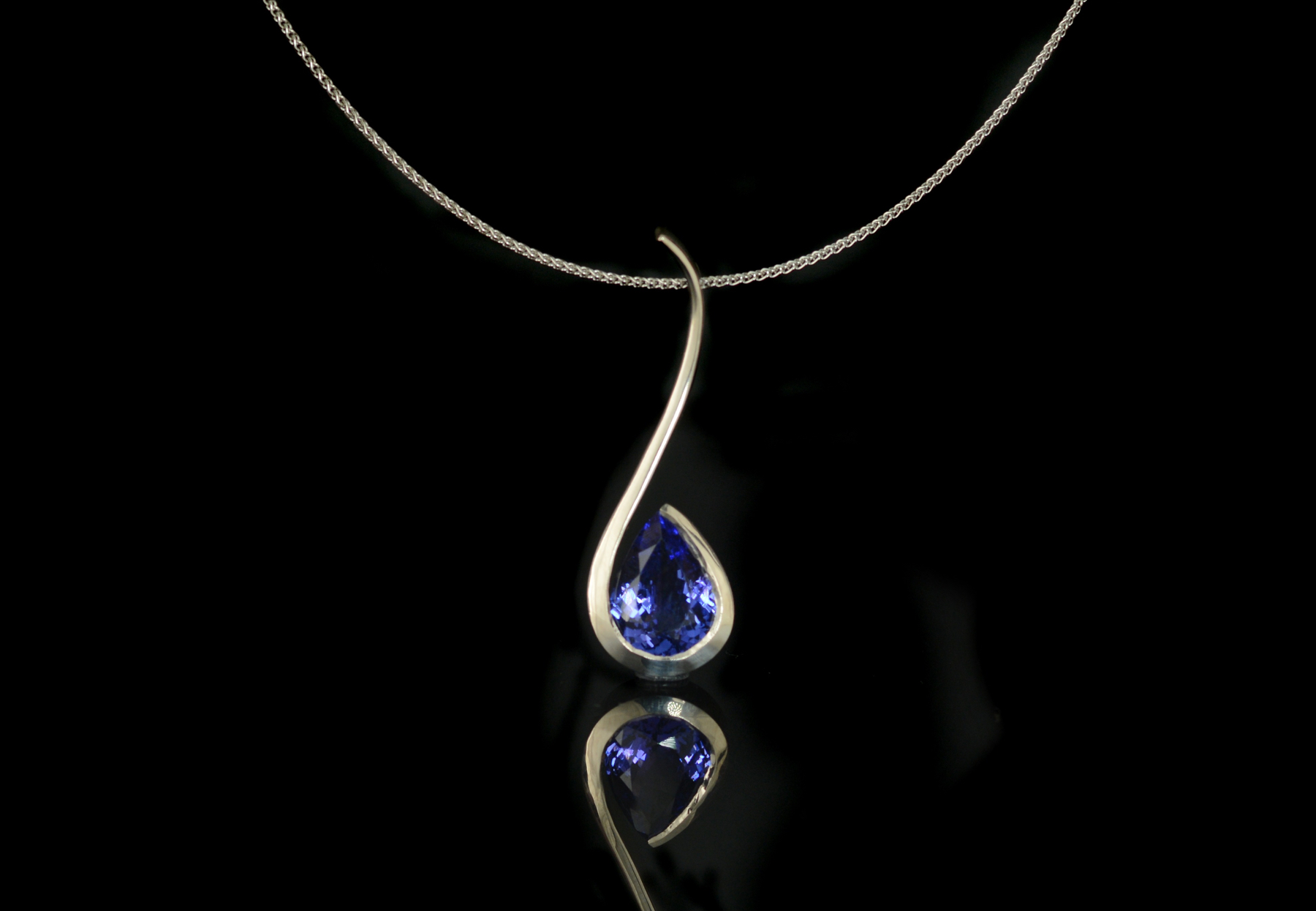 Forged white gold pendant with pear tanzanite