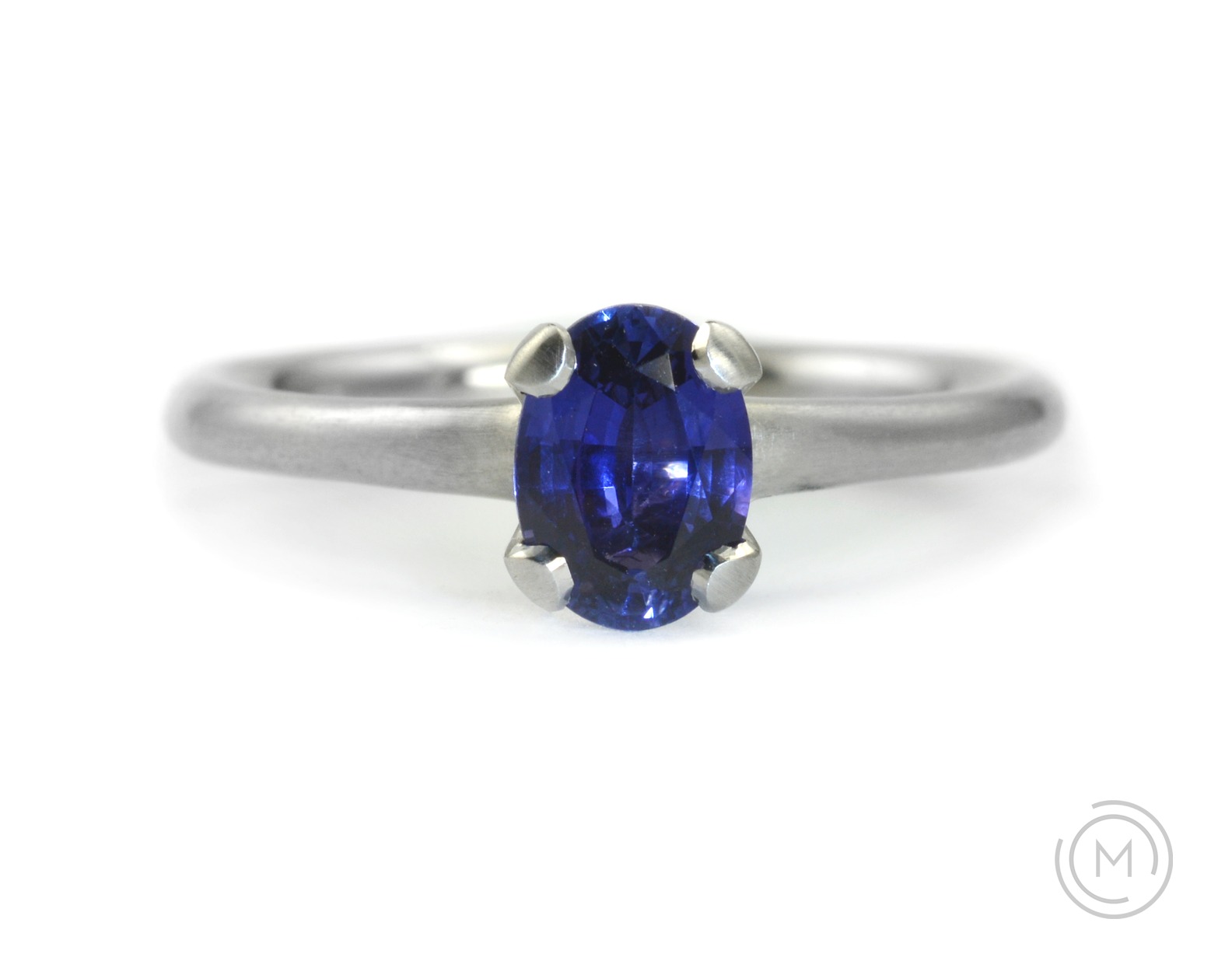 Oval sapphire and platinum 4-claw engagement ring