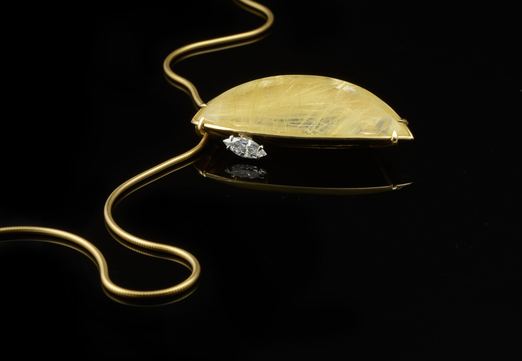 Yellow gold and rutilated quartz pendant