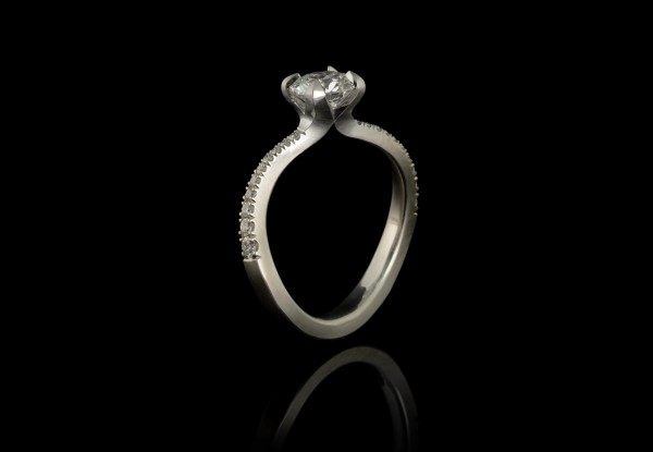Modern platinum and white diamond engagement ring with pave diamond band