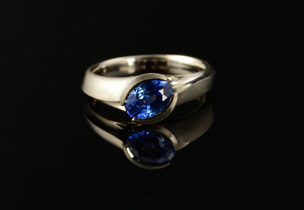 Carved white gold and blue sapphire engagement ring