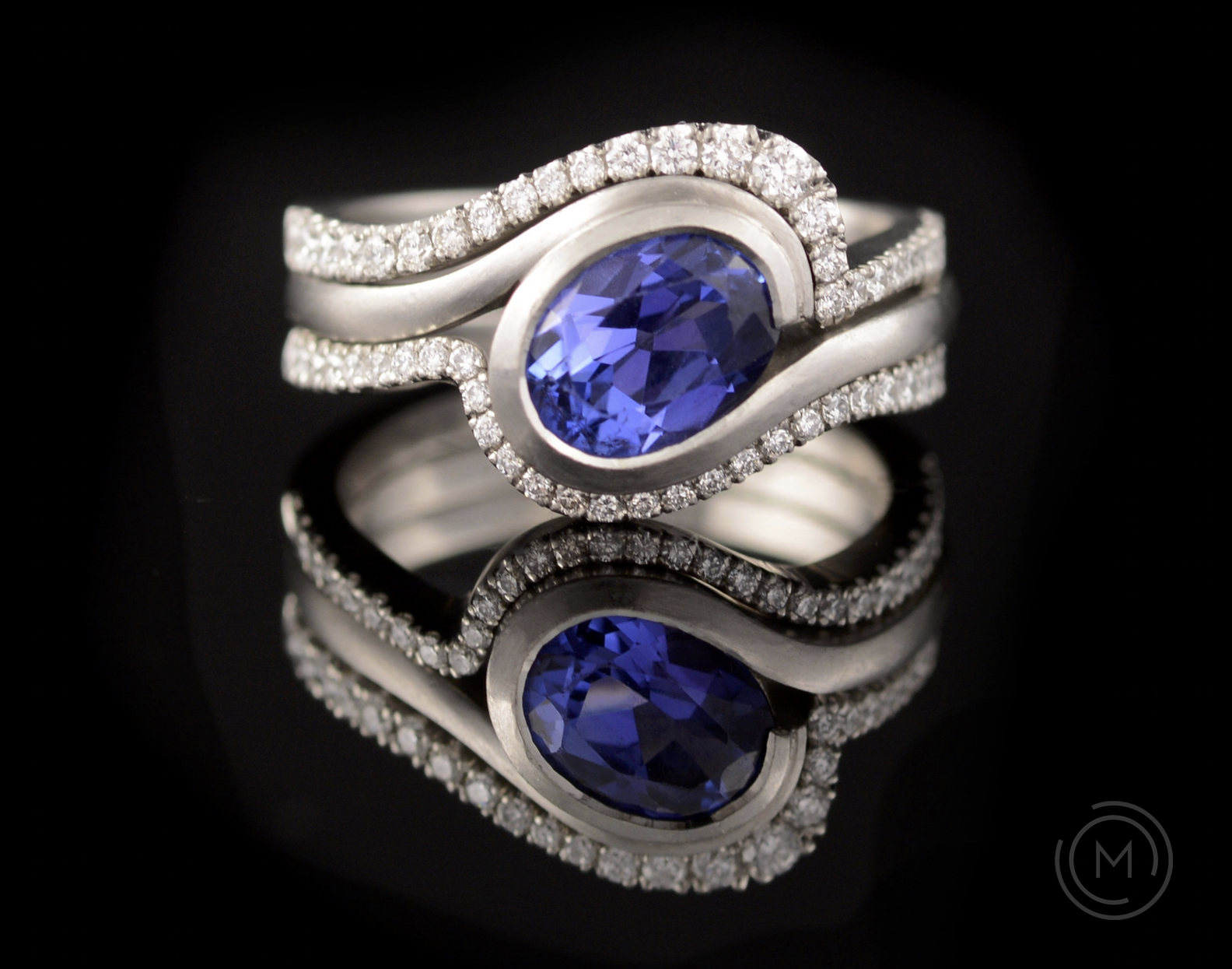 Tanzanite and white gold engagement ring with matching fitted diamond bands