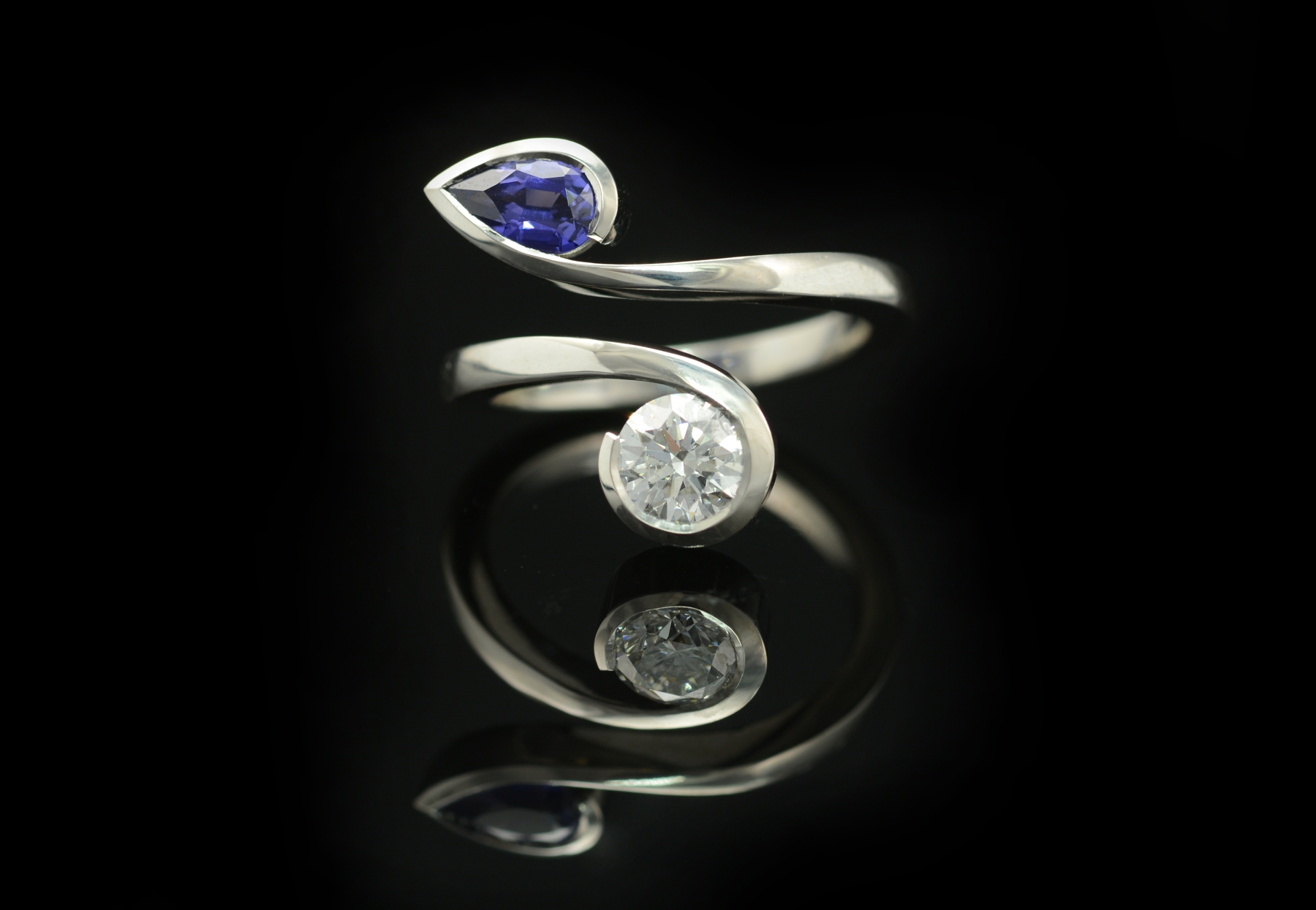 Two stone cocktail ring, hand forged from white gold and set with blue sapphire and white diamond