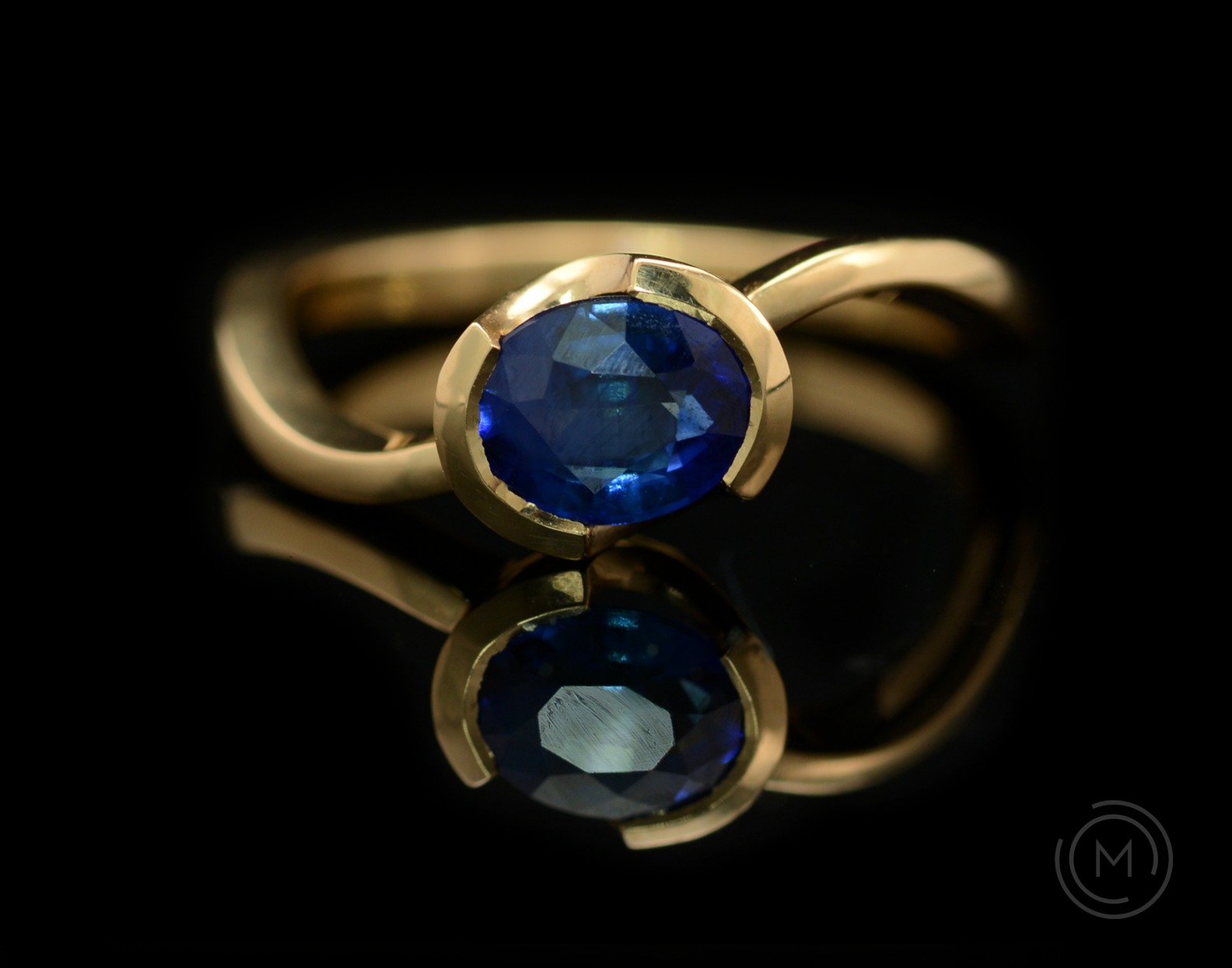 S-curve rose gold and blue sapphire engagement ring