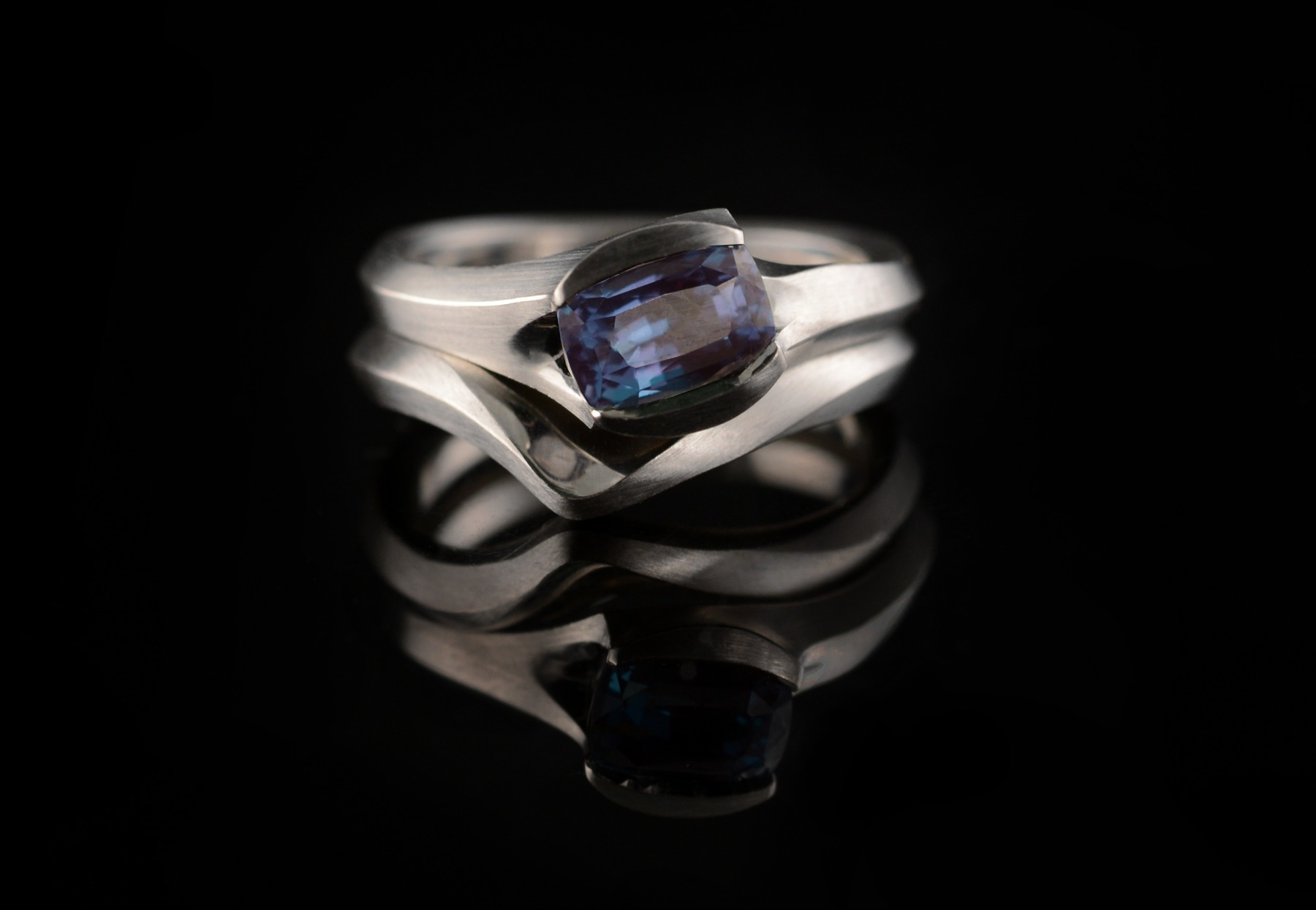 Alexandrite and platinum carved engagement ring with fitted wedding band