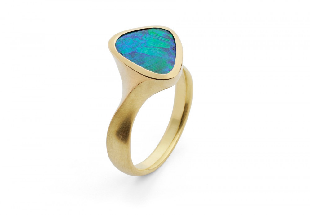 Carved yellow gold ring set with black opal
