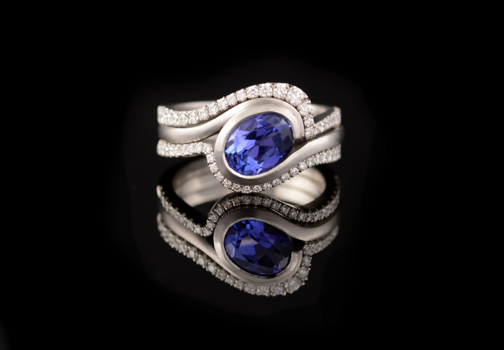 Tanzanite and platinum engagement ring with fitted diamond wedding bands