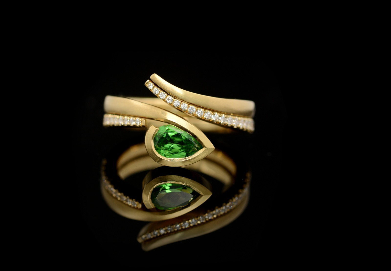 Green garnet twist engagement ring with fitted wedding band