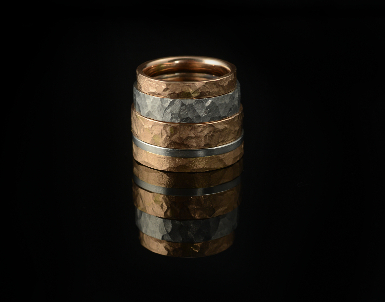 A stack of our hammered wedding rings in white, rose and yellow gold