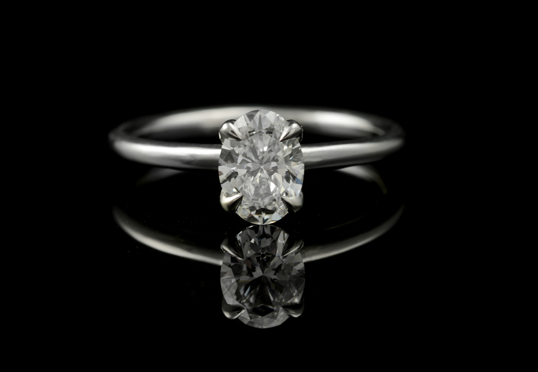 Platinum and oval white diamond 4-claw engagement ring