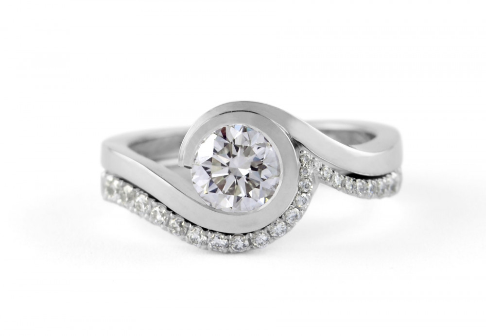 Contemporary platinum 'Wave' engagement ring with brililant white diamonds