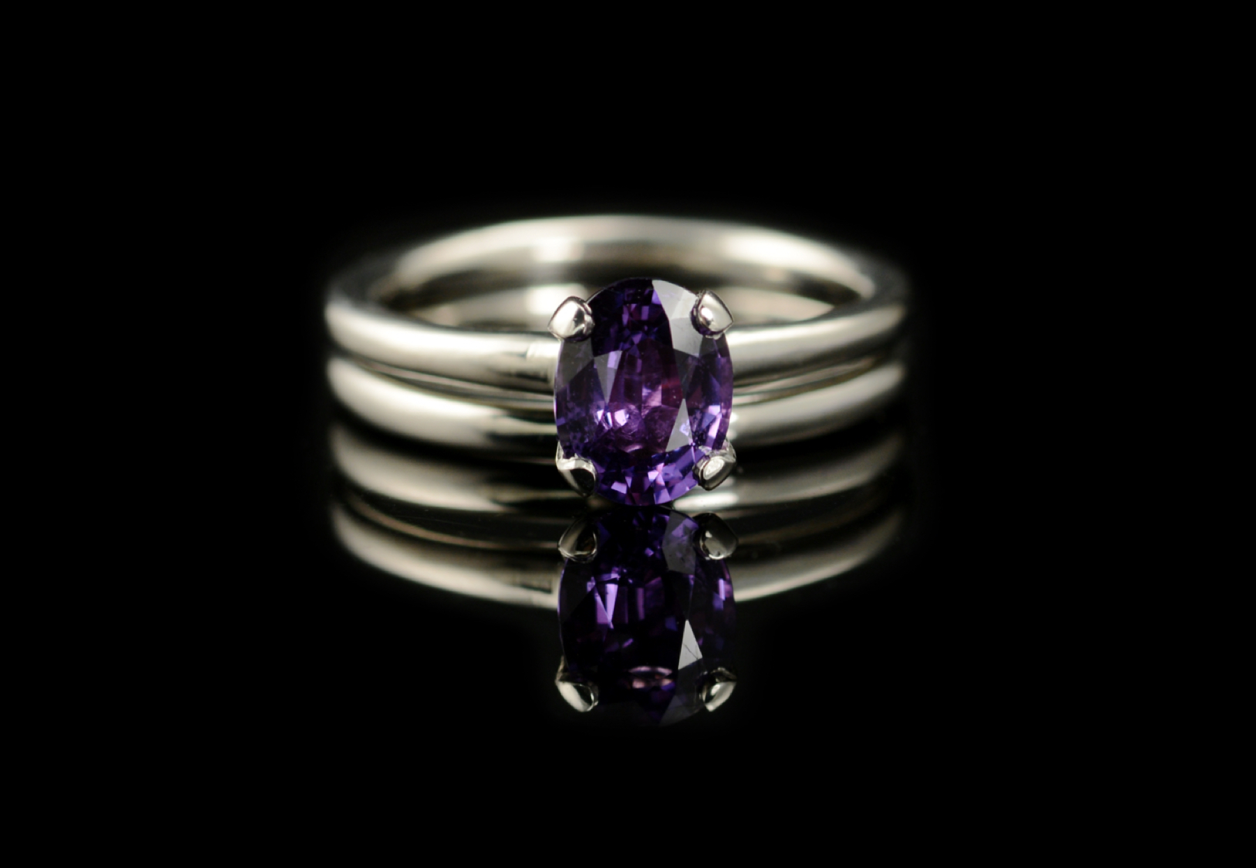 Oval purple sapphire 4-claw engagement ring with matching wedding ring