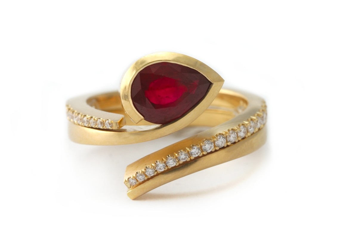 Gold and ruby engagement ring with fitted diamond wedding band