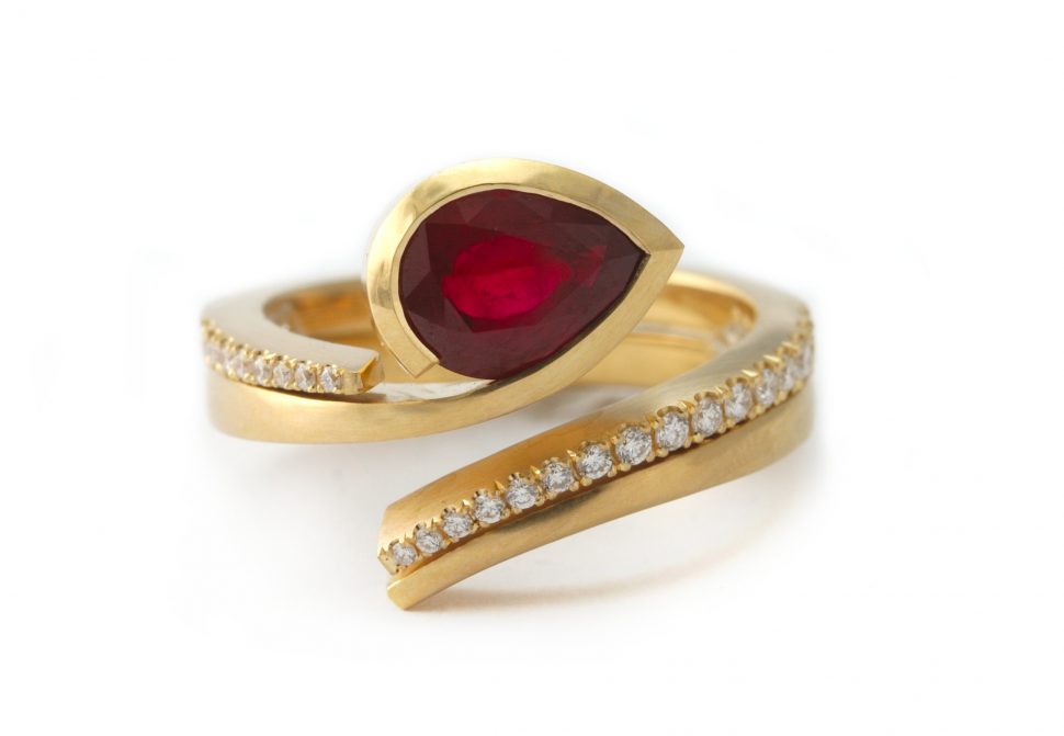 Gold and ruby engagement ring with fitted diamond wedding band