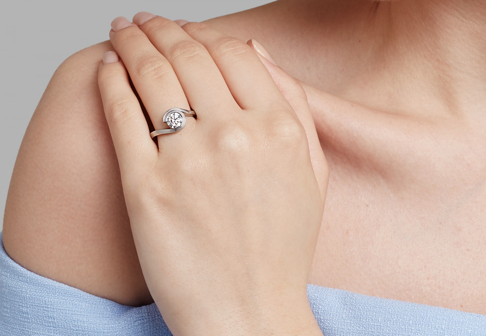 Platinum & diamond 'Wave' engagement ring on hand