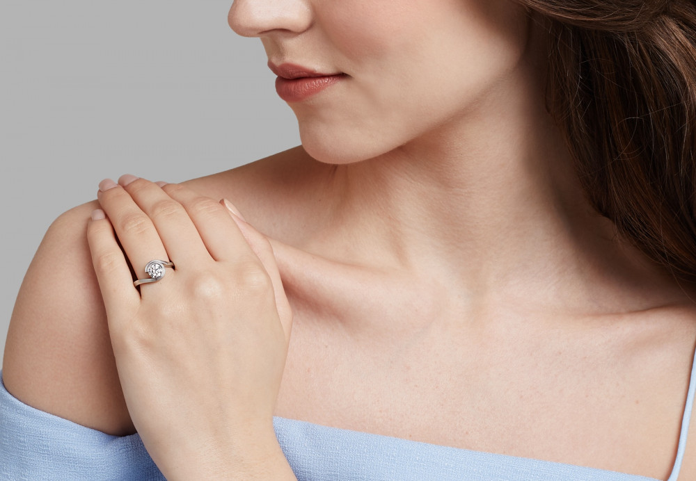 'Wave platinum & diamond engagement ring on hand